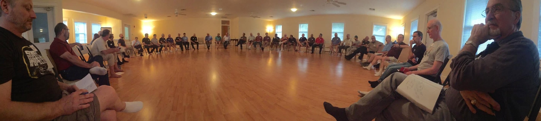 Men gathering in a spacious circle for thoughtful conversation